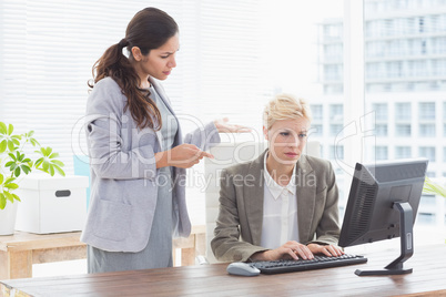 Businesswoman giving orders at her coworker