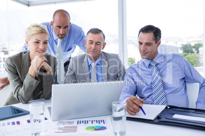 Business team working together on laptop