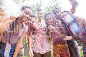 Happy friends covered in powder paint