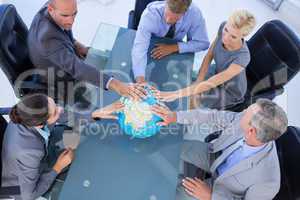 business people touching a globe