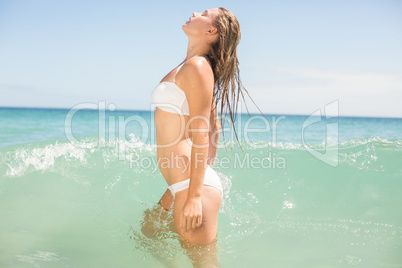 Pretty blonde bathing into the sea