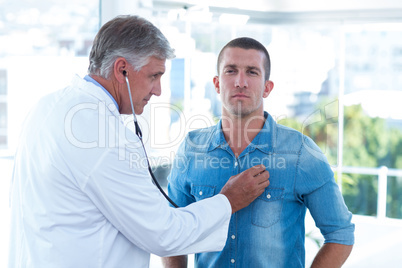 Doctor auscultating his patients chest