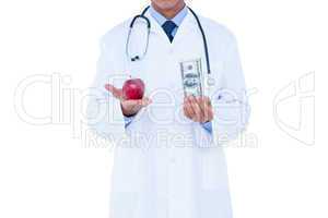Doctor holding cash and red apple