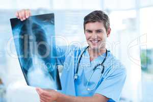 Smiling doctor analyzing xray