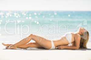 Pretty blonde woman relaxing beside the sea