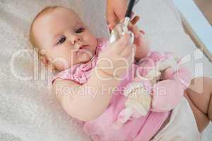 Beautiful cute baby girl with doctor with stethoscope