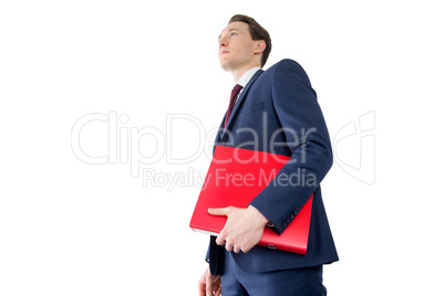 Thoughtful businessman holding red folder