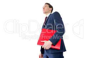 Thoughtful businessman holding red folder