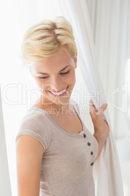 Pretty smiling blonde woman looking at on the ground