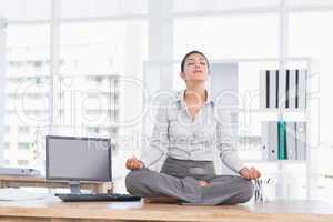 Businesswoman relaxing on her desk