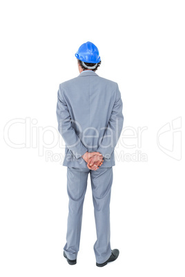 Businessman with helmet turning his back to camera