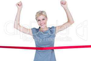 Happy businesswoman cutting red ribbon