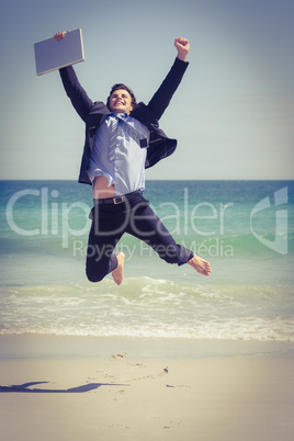 Excited businessman wearing suit jumping