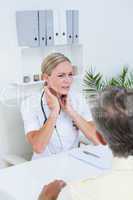 Doctor examining patient with neck ache