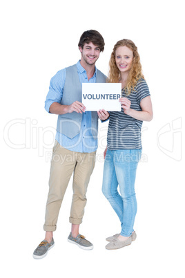 Happy couple holding a volunteer note
