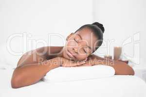 Peaceful pretty woman lying on massage table