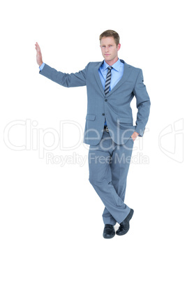 Businessman standing against wall