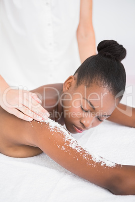 Pretty woman enjoying an exfoliation massage