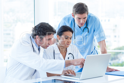 Team of doctors working on laptop Team of doctors working on laptop