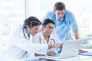 Team of doctors working on laptop