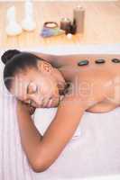 Pretty woman enjoying a hot stone massage