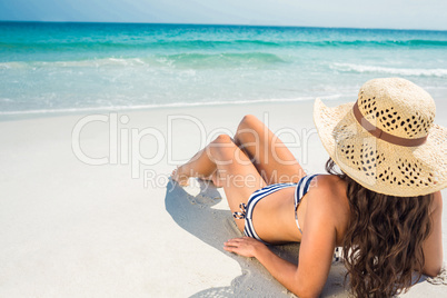 Rear view of pretty brunette looking at the ocean