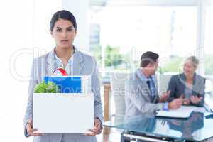 Businesswoman carrying her belongings in box