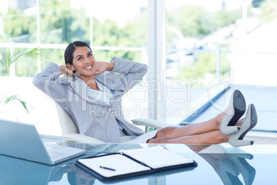 Businesswoman relaxing in a swivel chair