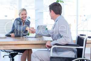 Businesswoman interviewing disabled job candidate
