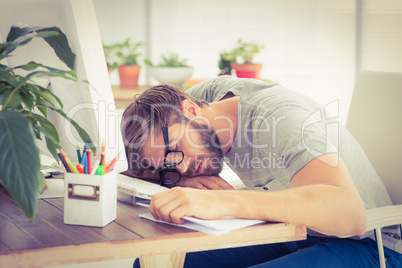 Exhausted businessman sleeping on the laptop