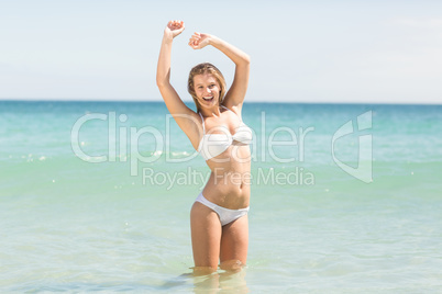 Happy pretty blonde cheering into the sea Happy pretty blonde cheering into the sea