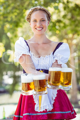 Pretty oktoberfest blonde holding beers