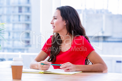 Concentrated woman taking notes during a meeting