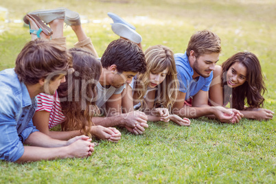 Friends lying and talking in the park