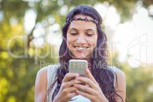 Pretty hipster using her smartphone