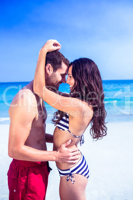Happy couple embracing at the beach