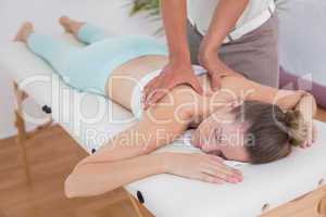 Physiotherapist doing back massage to his patient