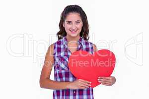 Pretty brunette holding paper heart