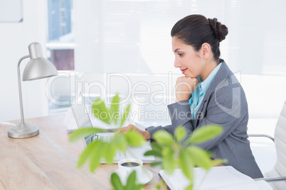 Smiling businesswoman using her computer