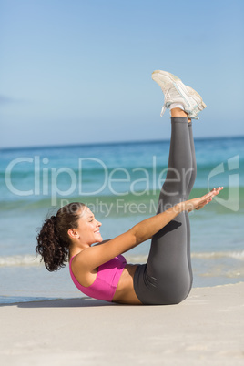 Fit woman doing fitness beside the sea