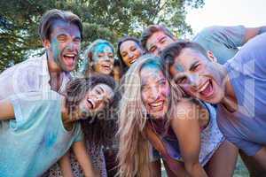 Happy friends covered in powder paint