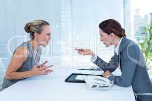 Businesswoman yelling at colleague