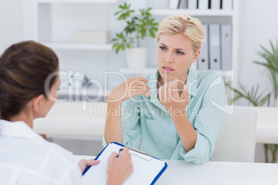 Unhappy patient speaking with doctor