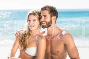 Happy couple relaxing together in the sand