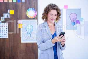 Creative businesswoman using her smartphone