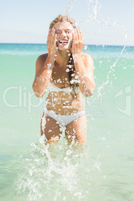 Pretty blonde watering her face