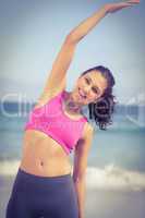 Pretty fit woman doing fitness beside the sea
