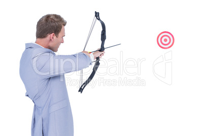 Businessman shooting target with arrow and bow