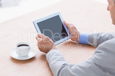 concentrating businessman using a tablet