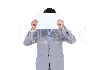 Businessman holding blank sign in front of his head